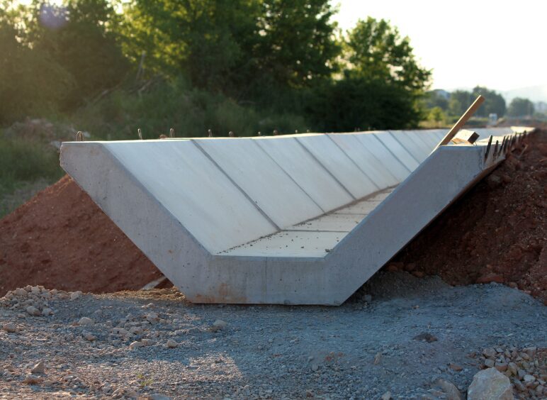 Concrete U-shaped drainage channel under construction.